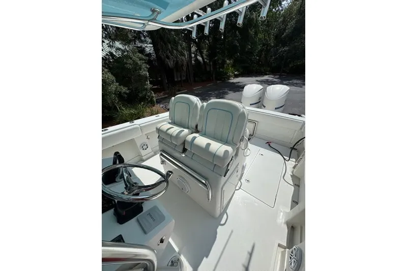 Slide: The Image of 2014 Jupiter 34 boat cockpit with dual seats and steering wheel. - 15