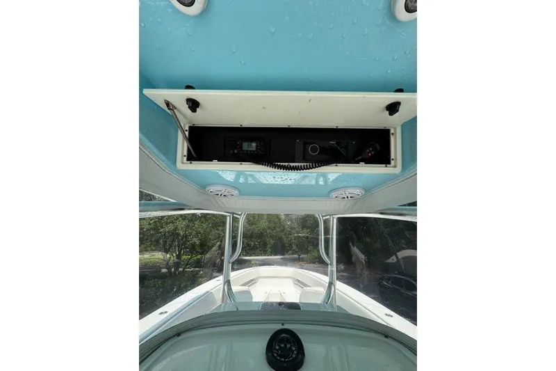 Slide: The Image of 2014 Jupiter 34 boat interior with open overhead compartment and visible electronics. - 16