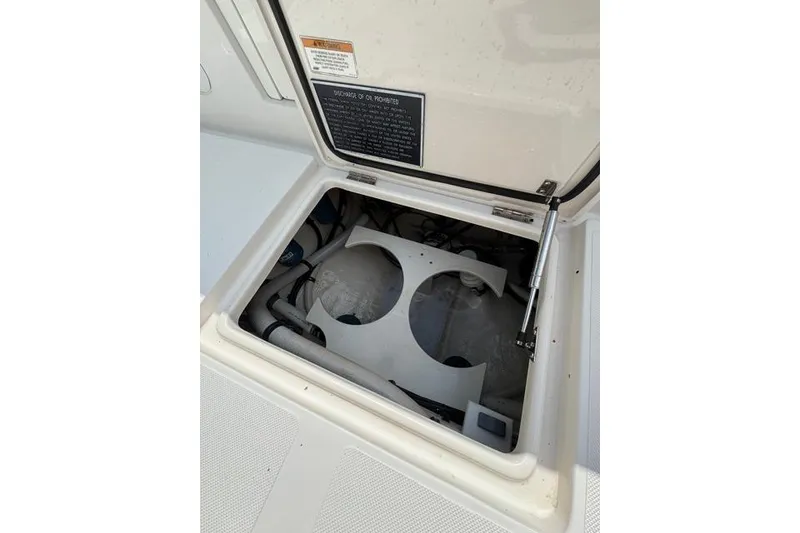 Slide: The Image of Open hatch on 2014 Jupiter 34 boat, revealing internal compartments and components. - 17