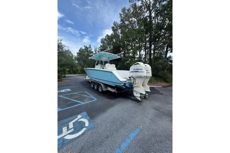Slide: The Image of 2014 Jupiter 34 boat with Yamaha engines in a parking lot. - 20