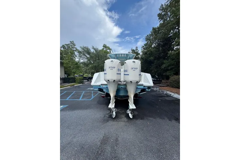 Slide: The Image of 2014 Jupiter 34 boat with twin Yamaha 350 engines parked outdoors. - 21