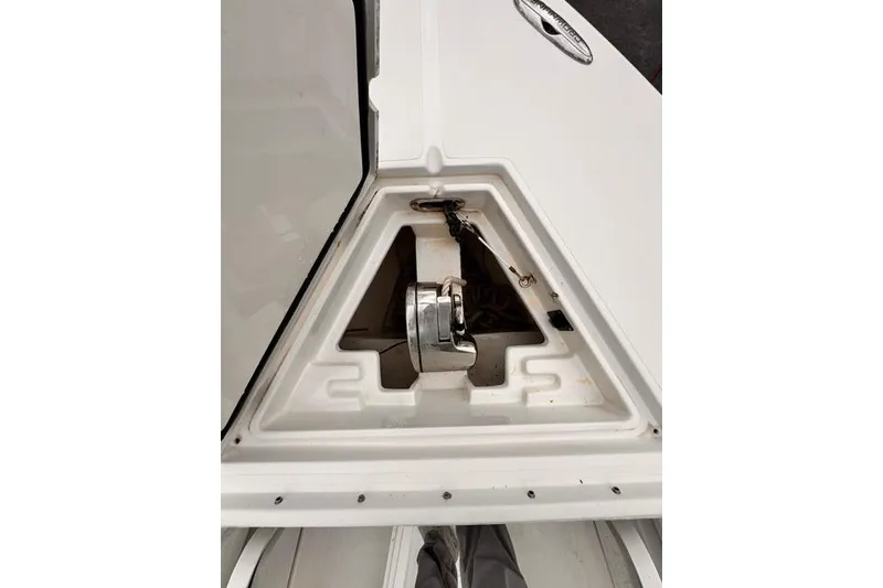 Slide: The Image of Anchor compartment of a 2014 Jupiter 34 boat, featuring a neatly stored anchor. - 25