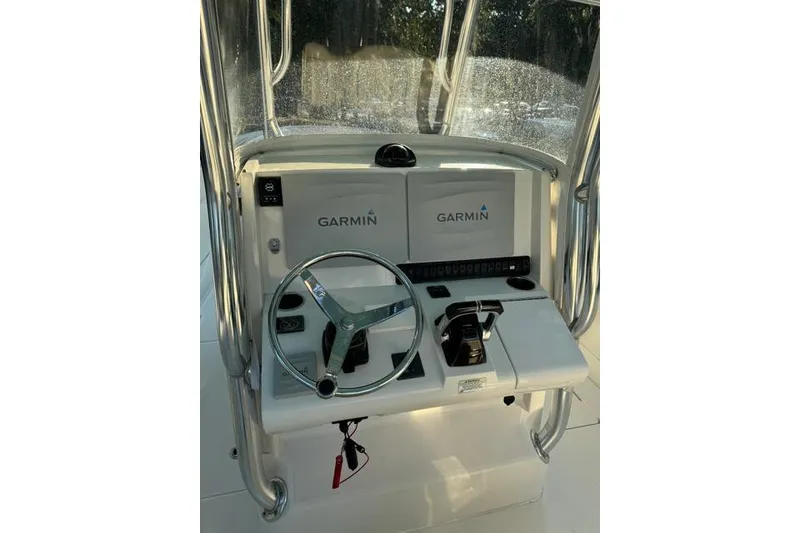 Slide: The Image of 2014 Jupiter 34 boat helm with Garmin navigation system and steering wheel. - 3