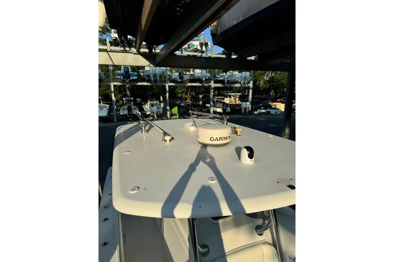 Slide: The Image of 2014 Jupiter 34 boat with Garmin equipment, docked in a marina under sunlight. - 4