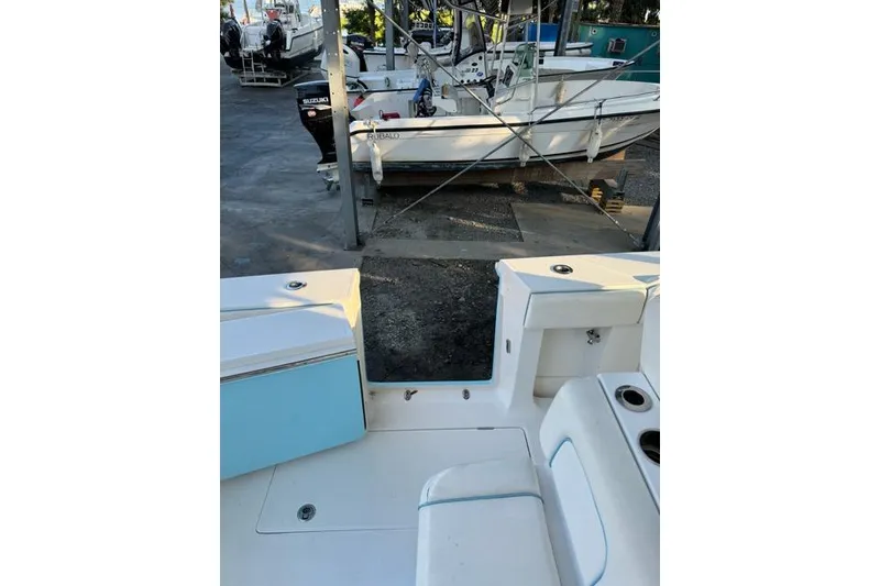 Slide: The Image of 2014 Jupiter 34 boat interior with seating and storage, docked near other boats. - 6