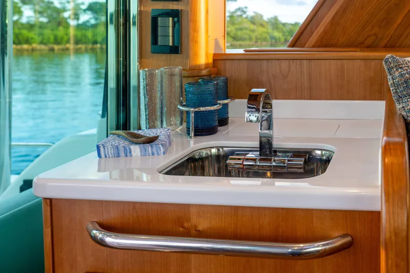 Slide: The Image of Luxurious interior of 2027 Sabre 51 Salon Express yacht with modern sink and scenic view. - 14