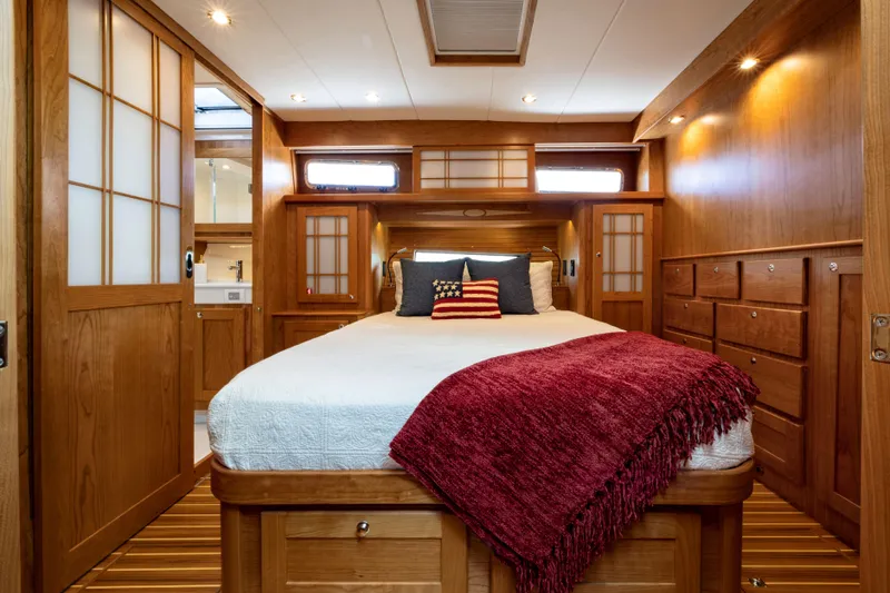 Slide: The Image of Luxurious bedroom interior of 2027 Sabre 51 Salon Express yacht with wooden finishes. - 20