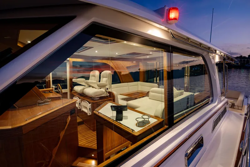 Slide: The Image of Luxurious interior of 2027 Sabre 51 Salon Express yacht at sunset, featuring elegant seating. - 22