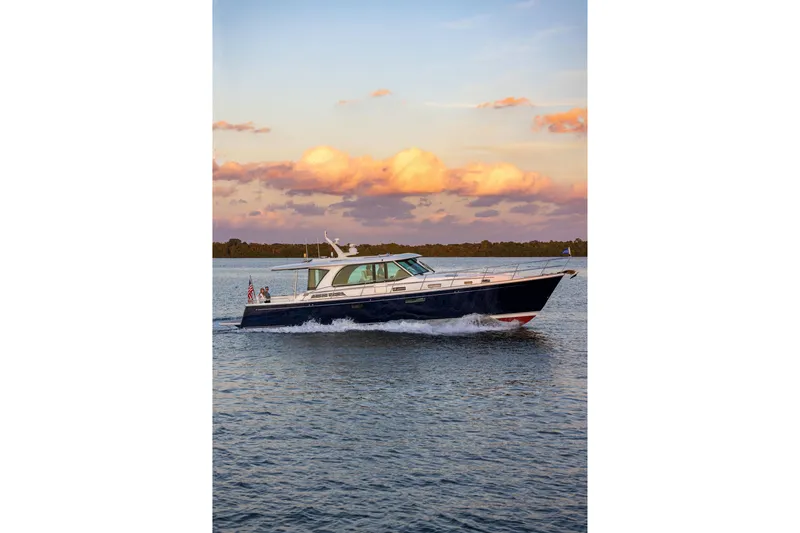 Slide: The Image of 2027 Sabre 51 Salon Express cruising on water at sunset. - 3