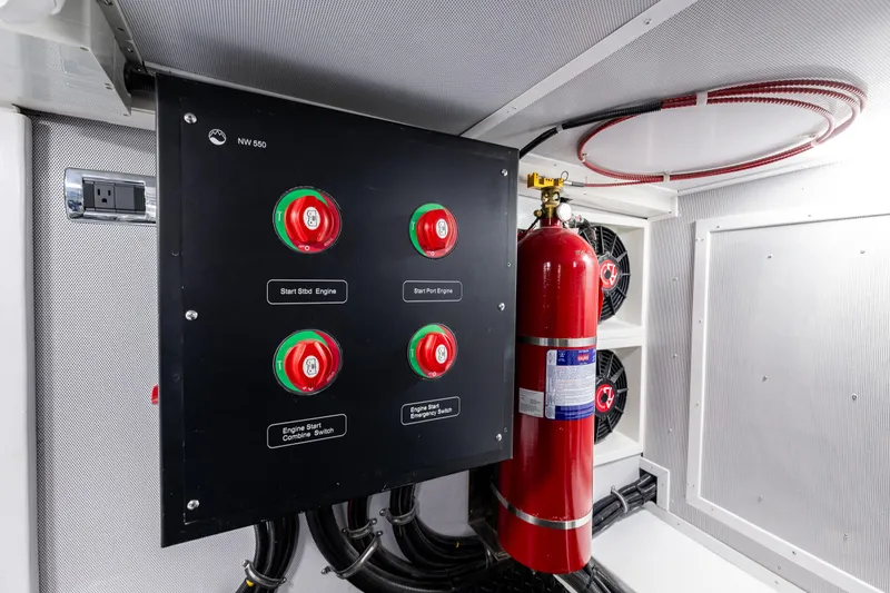Slide: The Image of Control panel with red switches and fire extinguisher in Northwest 55, 2024 model. - 12