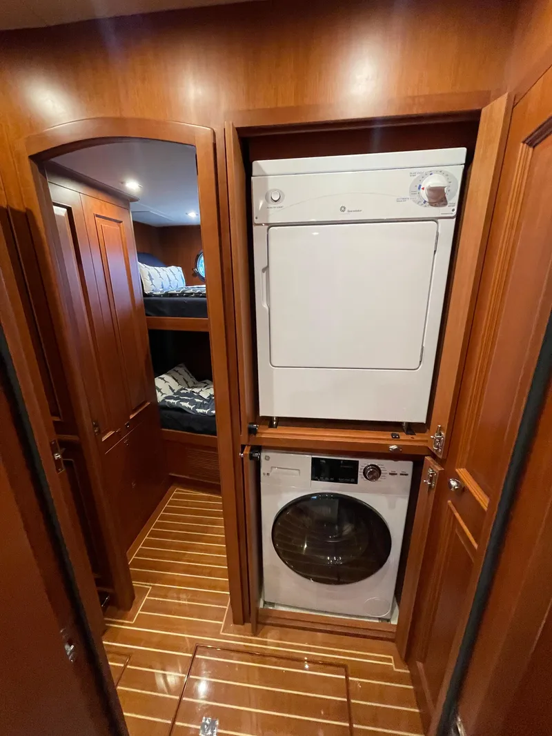 Slide: The Image of Laundry area with stacked washer and dryer in 2024 Northwest 55 yacht interior. - 28