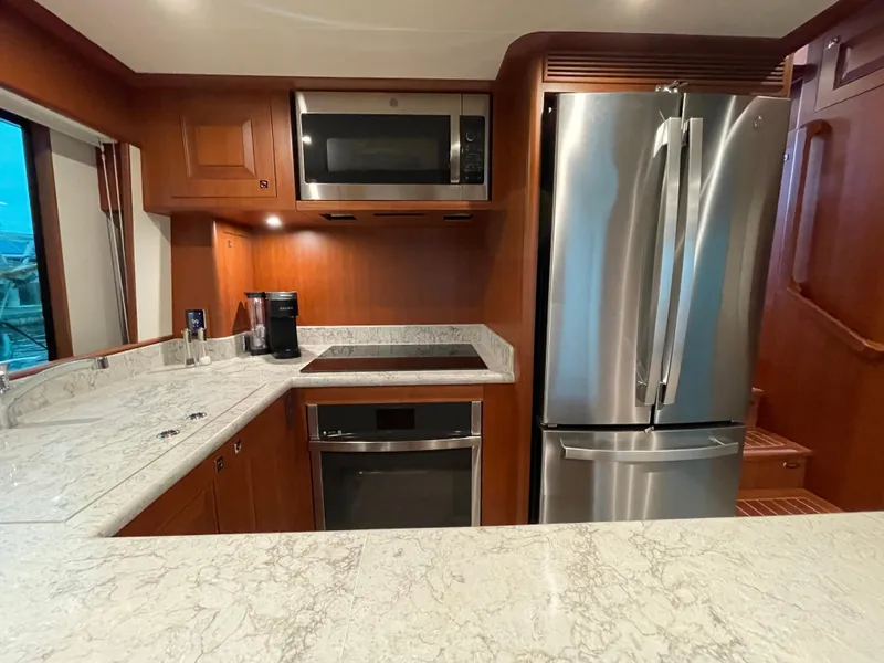 Slide: The Image of Modern kitchen in 2024 Northwest 55 yacht with stainless steel appliances and marble countertops. - 34