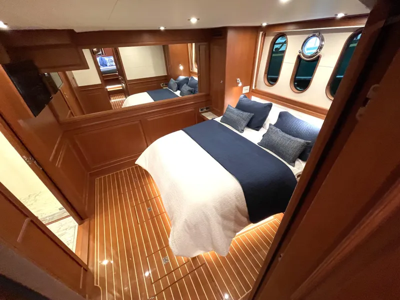 Slide: The Image of Luxurious cabin interior of 2024 Northwest 55 yacht with elegant wood finish and cozy bedding. - 35
