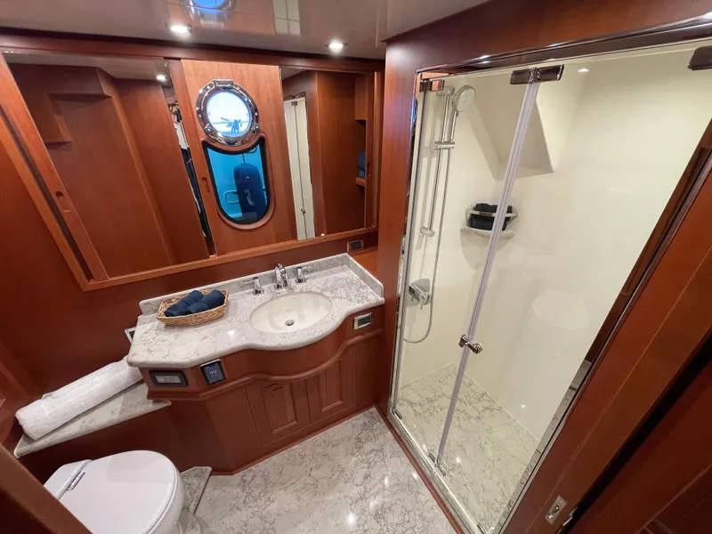 Slide: The Image of Luxurious bathroom in 2024 Northwest 55 yacht with marble countertop and glass shower. - 37