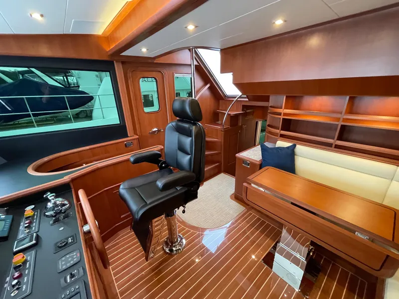 Slide: The Image of Luxurious 2024 Northwest 55 yacht interior with leather captain's chair and elegant wood finish. - 39