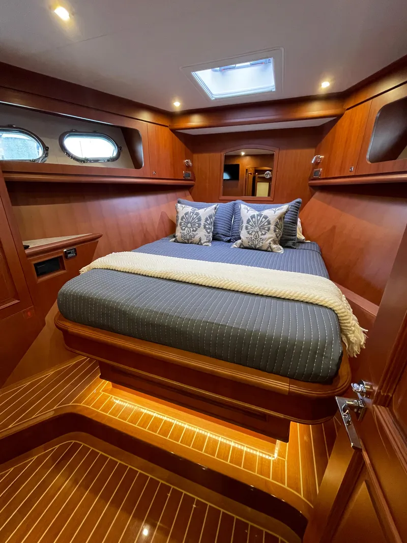 Slide: The Image of Luxurious cabin interior of 2024 Northwest 55 yacht with elegant wood finish and cozy bedding. - 46