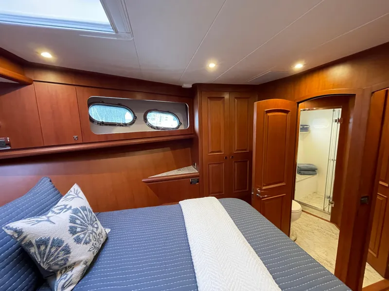 Slide: The Image of Luxurious cabin interior of 2024 Northwest 55 yacht with wood finish and ensuite bathroom. - 49