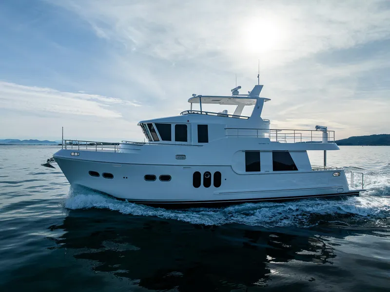 Slide: The Image of 2024 Northwest 55 yacht cruising on calm waters under a bright sky. - 6