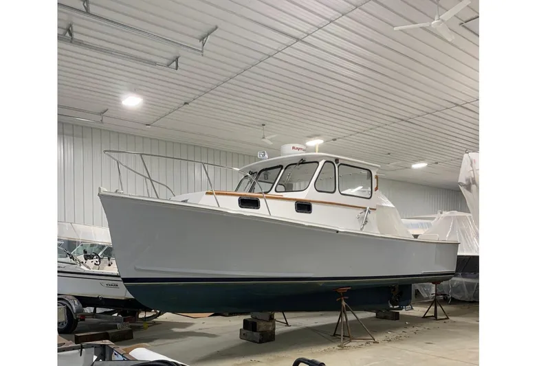 The Image of Johnson AJ28 boat from 2000 in a storage facility. - 1