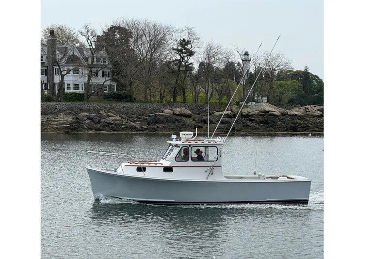 Slide: The Image of Johnson AJ28 boat from 2000 on calm water. - 2