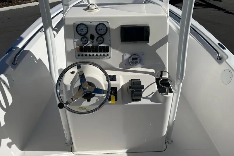 Slide: The Image of 2011 Tidewater 216 CC Adventure boat console with steering wheel and gauges. - 10
