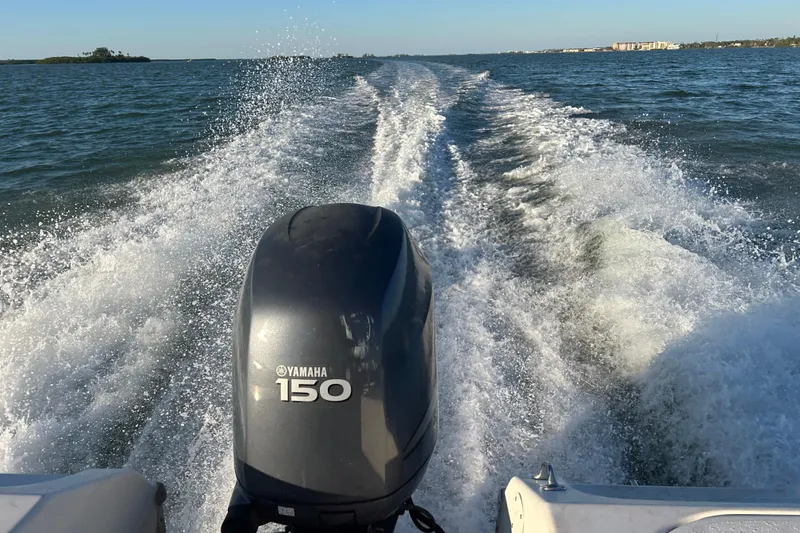 Slide: The Image of Tidewater 216 CC Adventure boat with Yamaha 150 engine cruising on open water. - 21