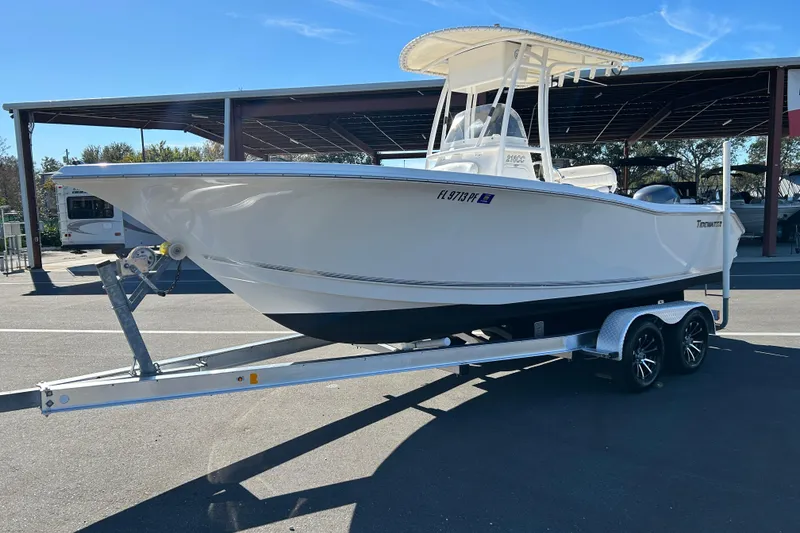Slide: The Image of 2011 Tidewater 216 CC Adventure boat on trailer in sunny outdoor setting. - 5