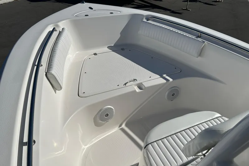Slide: The Image of 2011 Tidewater 216 CC Adventure boat interior with white seating and storage compartment. - 8