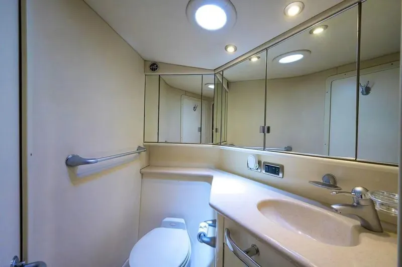 Slide: The Image of Luxurious bathroom in 2004 Sea Ray 550 Sundancer yacht, featuring modern fixtures and cabinetry. - 24