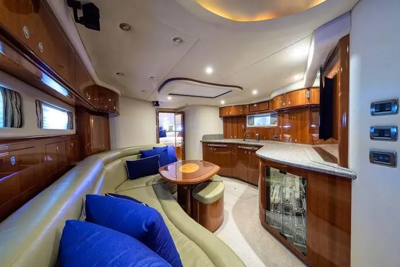 Slide: The Image of Luxurious interior of 2004 Sea Ray 550 Sundancer yacht with white seating and panoramic windows. - 6