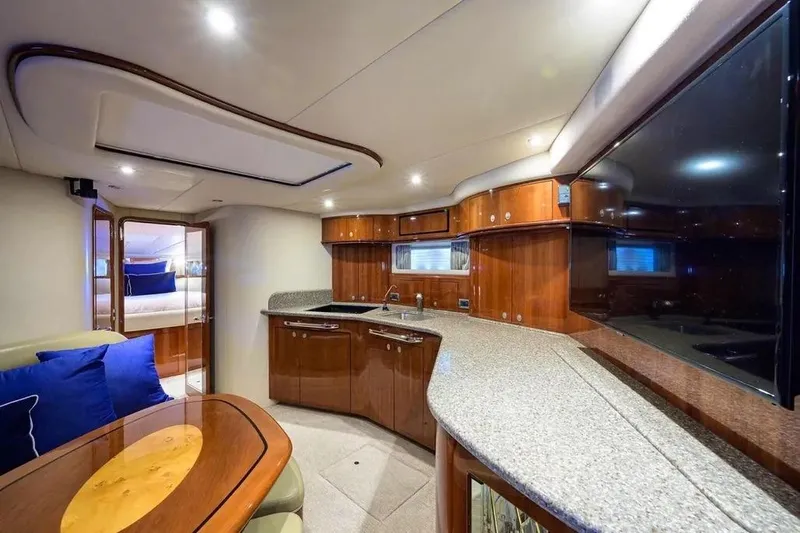 Slide: The Image of Luxurious interior of 2004 Sea Ray 550 Sundancer yacht with wooden cabinetry and blue cushions. - 7