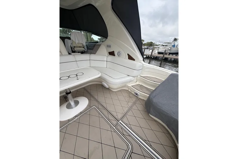 Slide: The Image of Interior of a 2004 Sea Ray 550 Sundancer yacht with covered seating. - 80