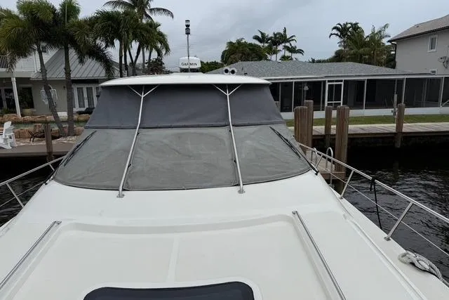Slide: The Image of Luxurious 2004 Sea Ray 550 Sundancer cabin interior with wood paneling and cozy bedding. - 90