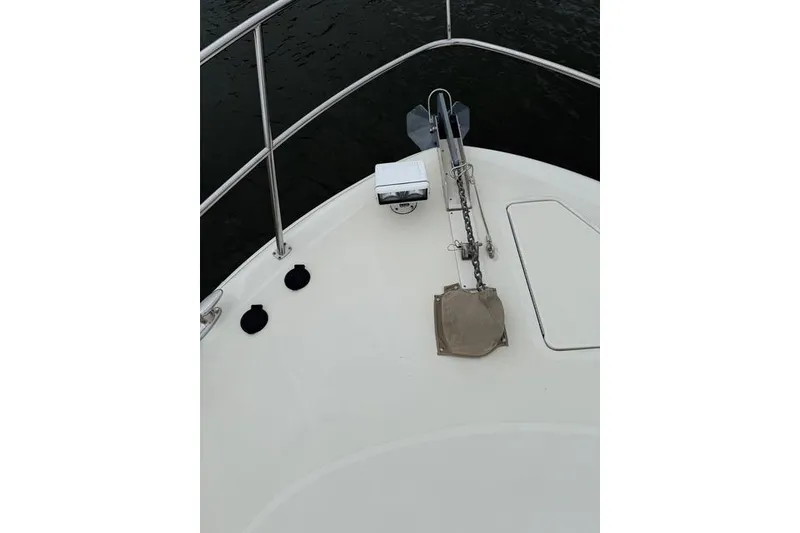 Slide: The Image of Luxurious 2004 Sea Ray 550 Sundancer cabin interior with wood paneling and cozy bedding. - 91