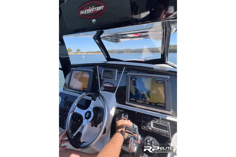 Slide: The Image of Cockpit view of 2013 Sunsation 34 CCX boat with navigation screens and steering wheel. - 15