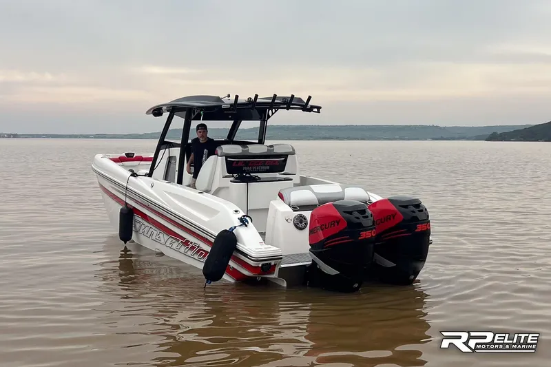 Slide: The Image of 2013 Sunsation 34 CCX boat with twin Mercury 350 engines on a calm lake. - 2
