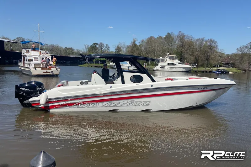 Slide: The Image of 2013 Sunsation 34 CCX boat on a calm river with other boats nearby. - 25