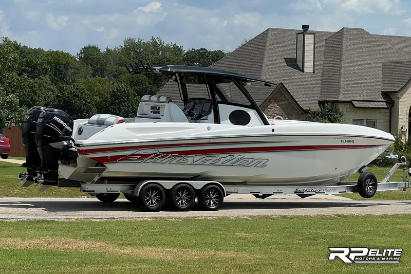 Slide: The Image of 2013 Sunsation 34 CCX boat on trailer, parked in residential area. - 28