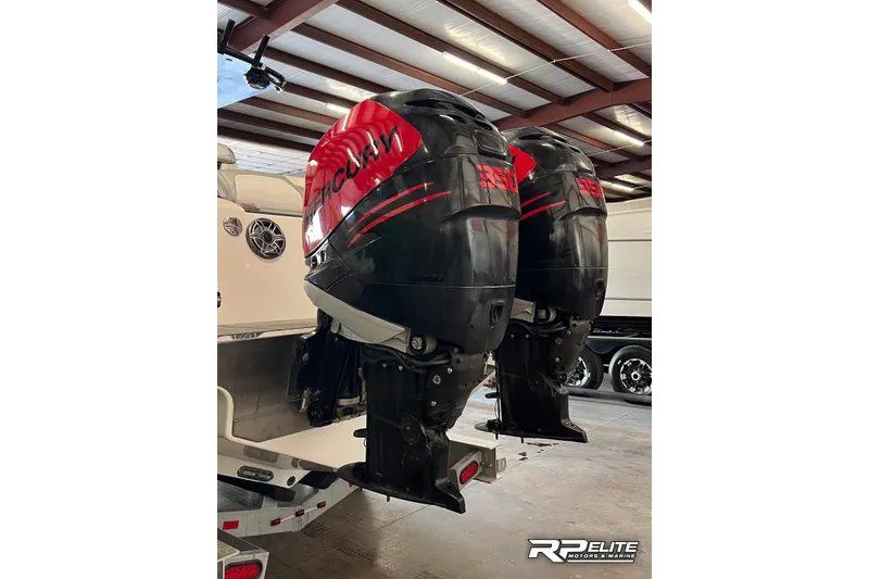 Slide: The Image of Twin Mercury 350 outboard engines on a 2013 Sunsation 34 CCX boat in a garage. - 6