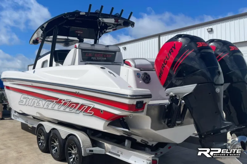 Slide: The Image of 2013 Sunsation 34 CCX boat with twin Mercury engines on a trailer. - 7