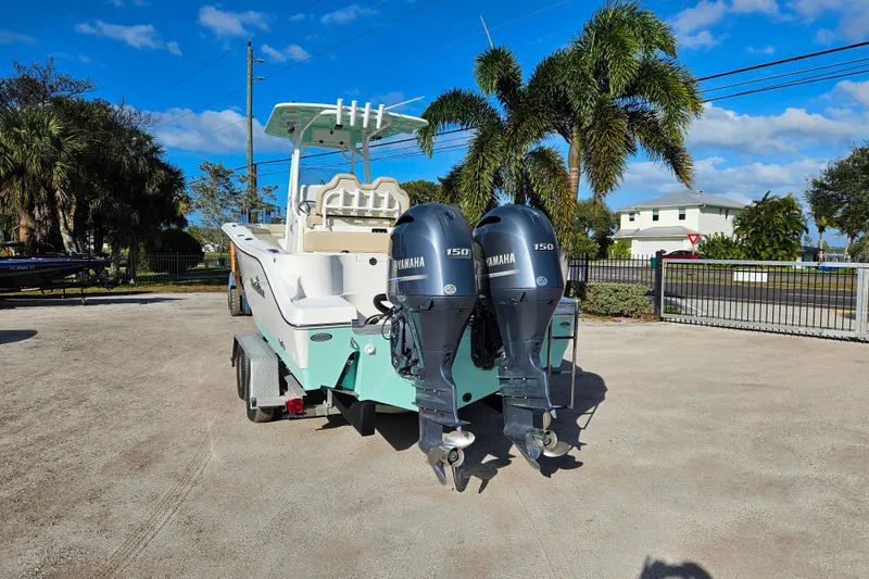 Slide: The Image of 2018 NauticStar 25 XS boat with dual Yamaha 150 engines on a trailer. - 3