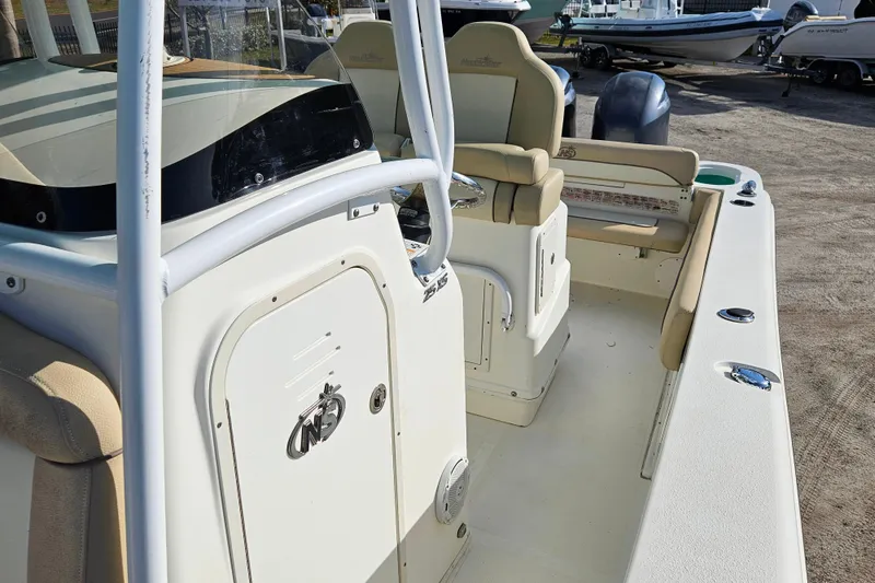 Slide: The Image of 2018 NauticStar 25 XS boat interior with seating and console details. - 8
