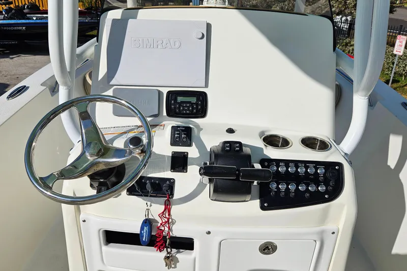 Slide: The Image of 2018 NauticStar 25 XS boat console with steering wheel and control panel. - 9