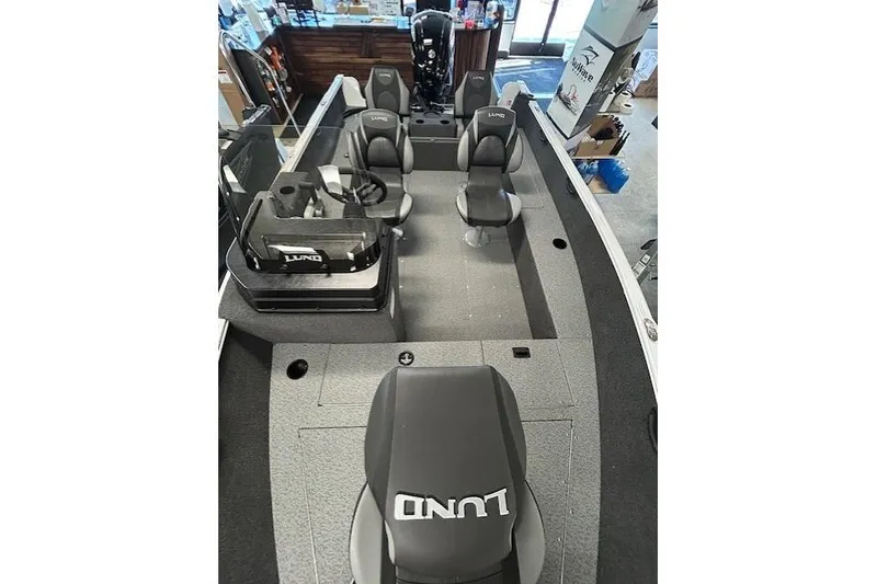Slide: The Image of 2026 Lund 1650 Rebel XL SS boat interior with steering wheel and seating. - 13