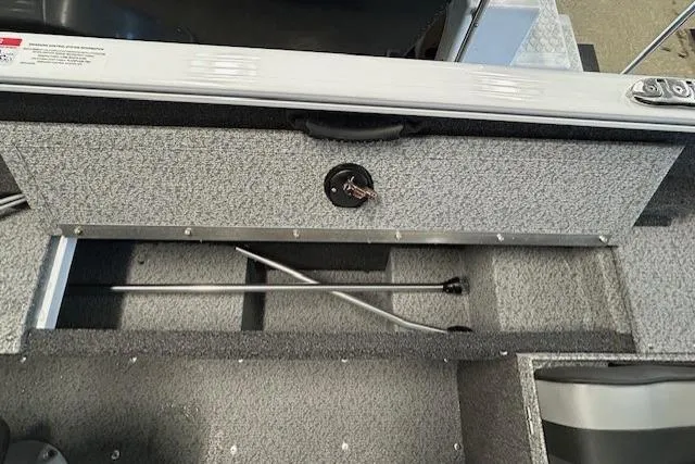 Slide: The Image of 2026 Lund 1650 Rebel XL SS boat interior with seating and storage compartments. - 15