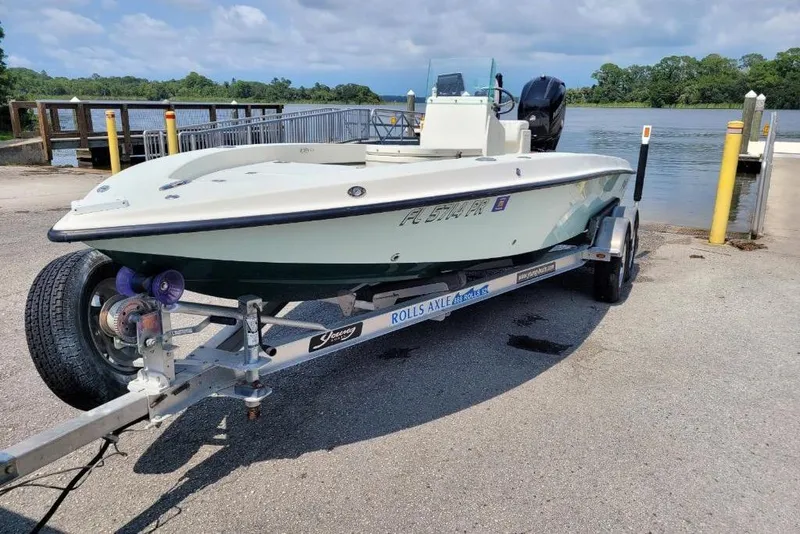 The Image of 2014 Young Boats 20 Bay Boat on trailer under clear blue sky. - 0