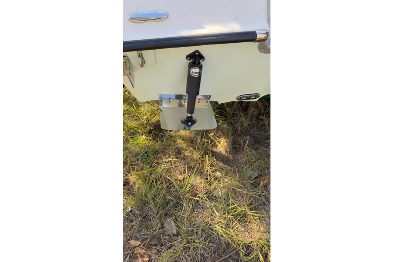 Slide: The Image of 2014 Young Boats 20 Bay Boat interior with seating and console, docked outdoors. - 12