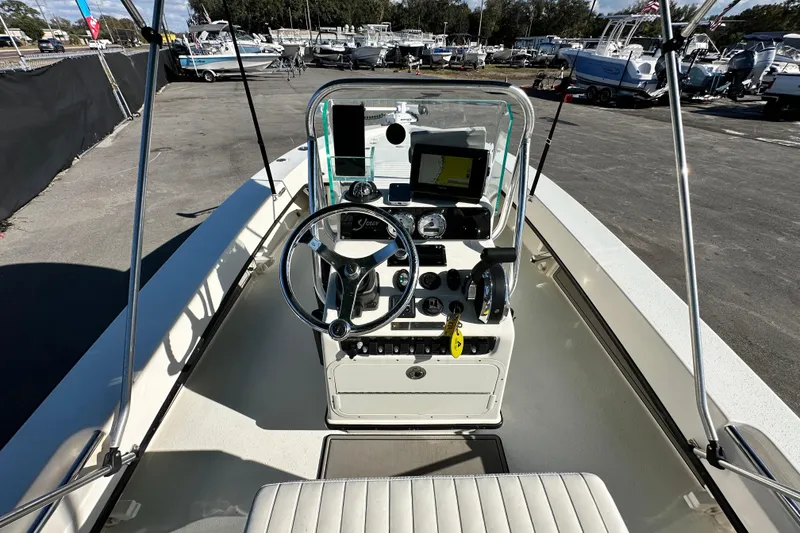 Slide: The Image of 2014 Young Boats 20 Bay Boat cockpit with steering wheel and navigation equipment. - 15