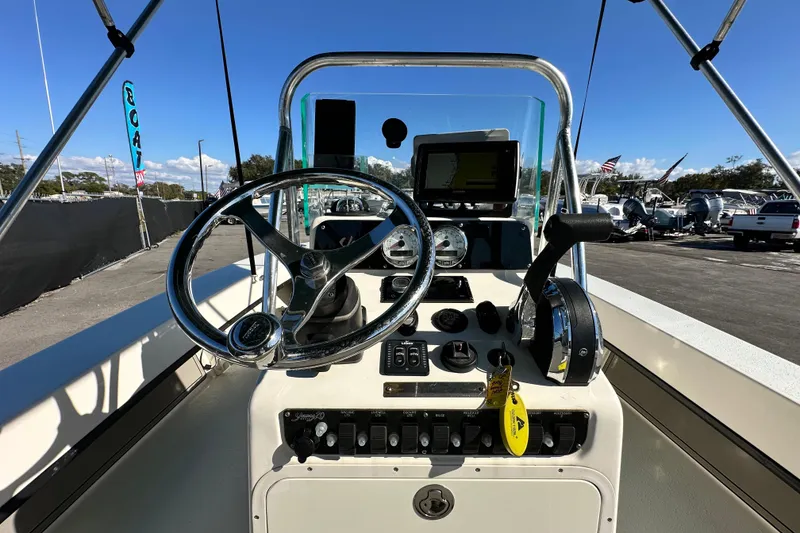 Slide: The Image of 2014 Young Boats 20 Bay Boat dashboard with steering wheel and controls. - 16