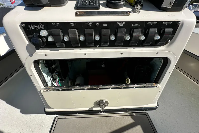 Slide: The Image of Control panel of a 2014 Young Boats 20 bay boat with labeled switches. - 18